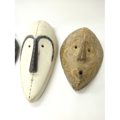 6292 - African hand carved masks including fang masks (3) 36cm x 32cm x 28cm tall