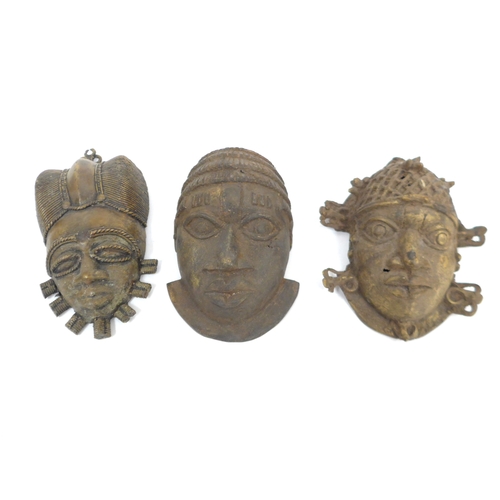 6317 - Three Benin cast metal/pendant masks in the form of human faces one with openwork beaded headdress 1... 