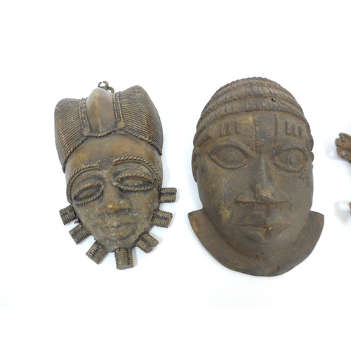 6317 - Three Benin cast metal/pendant masks in the form of human faces one with openwork beaded headdress 1... 