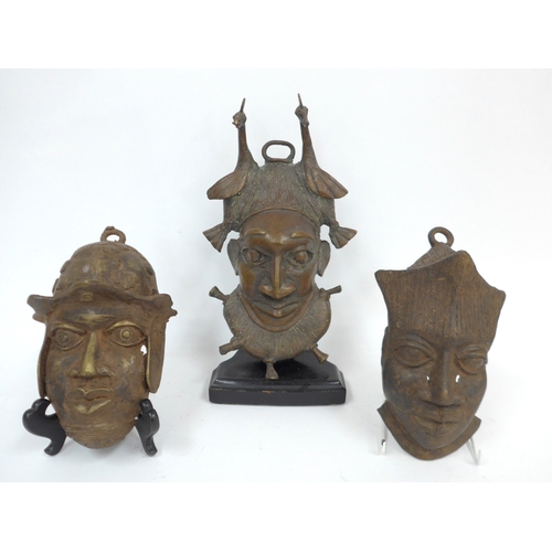 6320 - Three Benin bronze pendant masks including Portuguese soldier and a figure with birds in hair. 28cm ... 