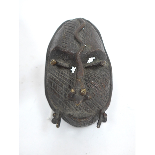 6318 - Two Nigerian cast metal masks with lizard detail. Holes present to both. 28cm and 12.5cm tall