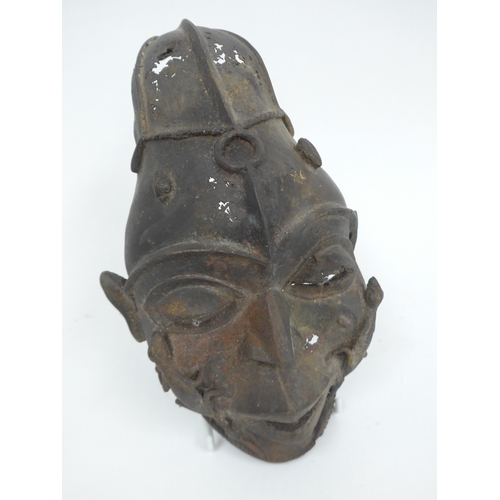 6318 - Two Nigerian cast metal masks with lizard detail. Holes present to both. 28cm and 12.5cm tall