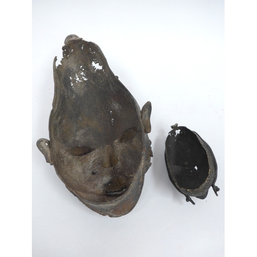 6318 - Two Nigerian cast metal masks with lizard detail. Holes present to both. 28cm and 12.5cm tall