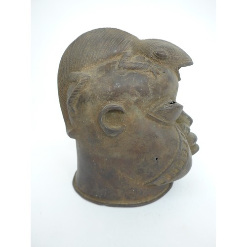 6311 - An African Benin bronze warrior head surmounted by a lizard, holes present to casting. 24cm tall x 1... 