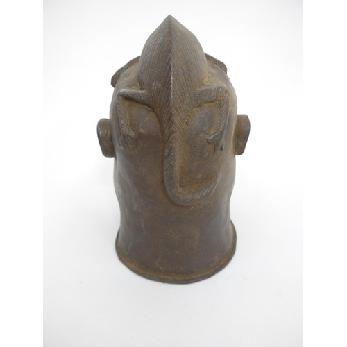 6311 - An African Benin bronze warrior head surmounted by a lizard, holes present to casting. 24cm tall x 1... 