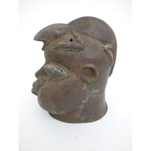 6311 - An African Benin bronze warrior head surmounted by a lizard, holes present to casting. 24cm tall x 1... 