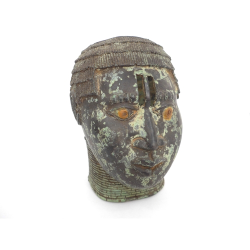 6313 - An African cast metal head of tribal female. Opening to top of head, 19.5cm x 13cm x 15cm