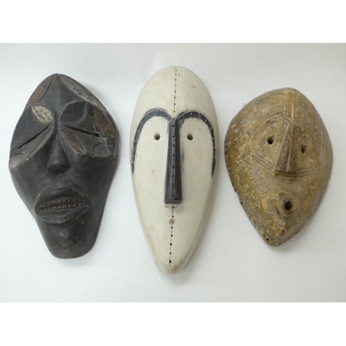 6292 - African hand carved masks including fang masks (3) 36cm x 32cm x 28cm tall