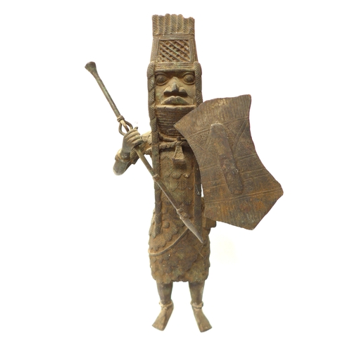 6295 - An Edo Benin bronze sculpture of a standing male warrior with spear and shield, 43cm tall