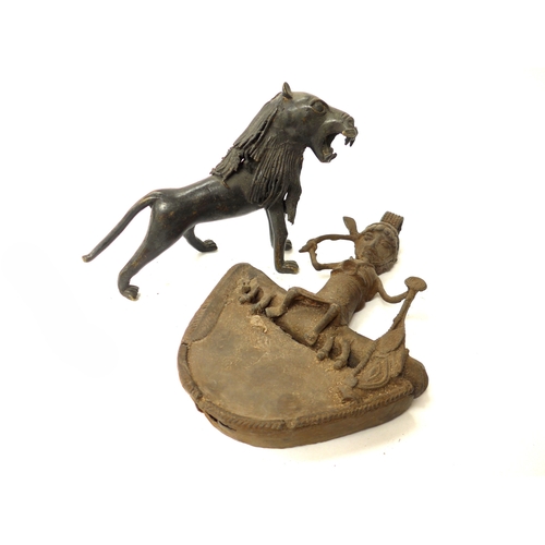 6302 - An African bronze statuette of a lion. 16.5cm tall x 25cm plus a bronze relief rider, Tada culture, ... 