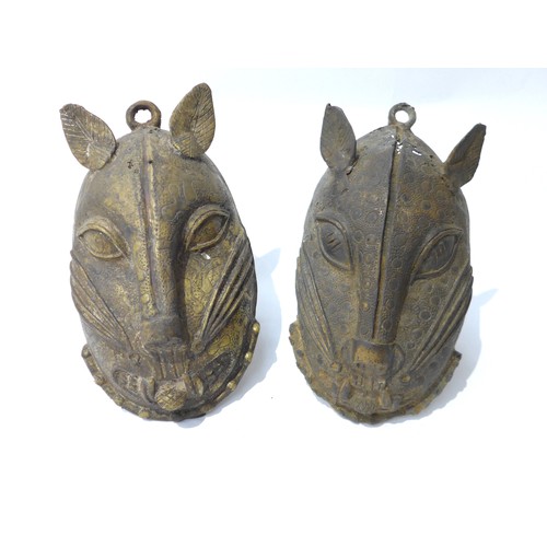 6307 - Two Benin bronze pendant masks of leopards, holes present. 21cm tall and 22.5cm tall