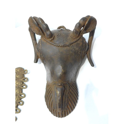 6306 - A bronze Owo rams head pendant. 'Osanmasinmi' Nigerian and a smaller example 30cm and 21cm