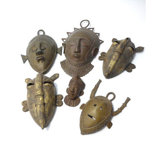 6305 - Six various cast metal African pendant masks, human form and zoomorphic, varying in sizes. Smallest ... 