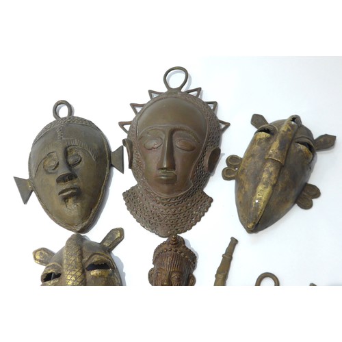 6305 - Six various cast metal African pendant masks, human form and zoomorphic, varying in sizes. Smallest ... 