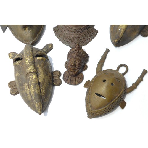 6305 - Six various cast metal African pendant masks, human form and zoomorphic, varying in sizes. Smallest ... 