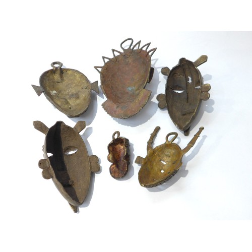 6305 - Six various cast metal African pendant masks, human form and zoomorphic, varying in sizes. Smallest ... 