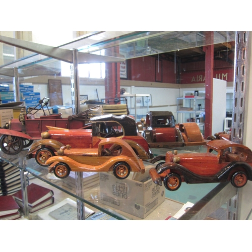 5098 - Three wooden models of vintage cars and a resin example