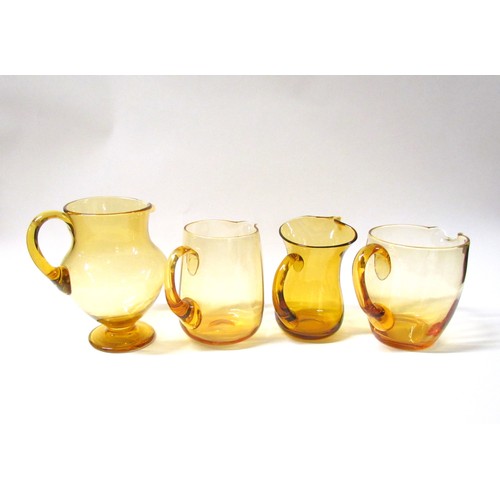 1314 - Four Amber glass jugs including Whitefriars.  Tallest 20cm