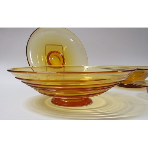 1321 - Four Amber glass bowls including Whitefriars trailed example.  Largest diameter 29.5cm