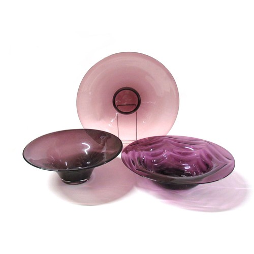 1322 - Three large amethyst glass bowls including Whitefriars waved example.  Largest diameter 26cm