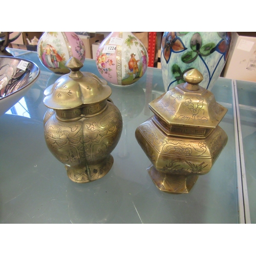 1338 - Two brass embossed urns with covers, approximately 17cm tall