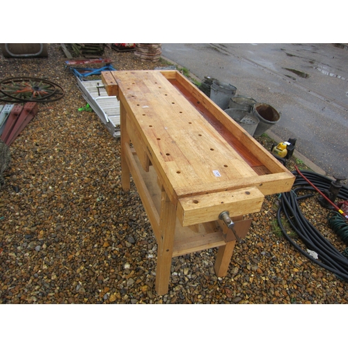 3297 - A wooden work bench with vices