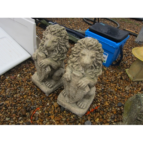 3303 - A pair of composition Lions holding shields