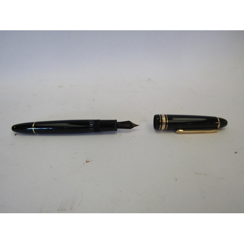 1377 - A Meisterstuck Montblanc fountain pen, black with gilt clip and fittings, the two colour nib stamped... 