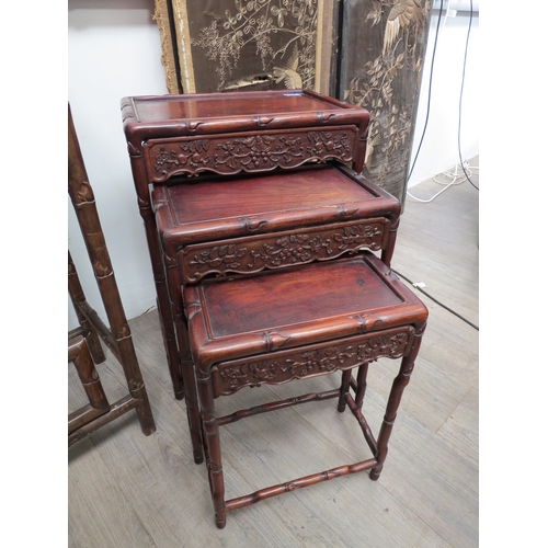 6016 - A nest of three Chinese padouk wood occasional tables with foliate decoration, largest 65cm x 45cm x... 