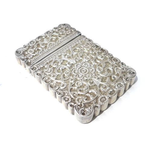 6392 - A white metal cardcase with all over floral leaf design, 10cm x 7cm