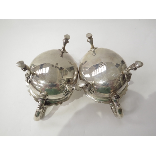 6445 - A pair of William Comyns & Sons silver sauce boats with scroll handles and hoof feet, London 1937, 1... 