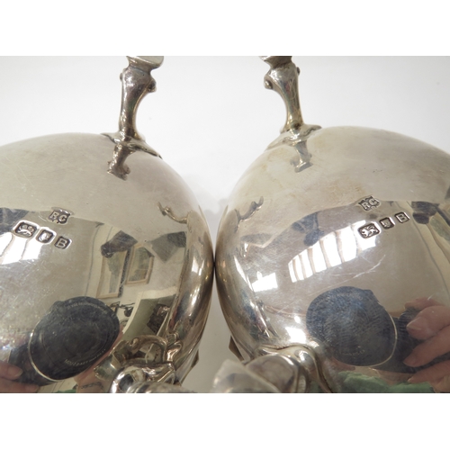 6445 - A pair of William Comyns & Sons silver sauce boats with scroll handles and hoof feet, London 1937, 1... 