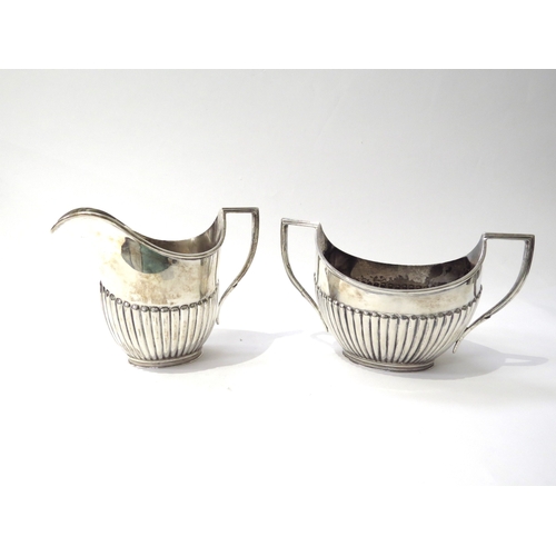 6433 - A Vander & Hedges silver milk jug and sugar bowl with melon fluted detail, London 1937, 10.5cm and 9... 