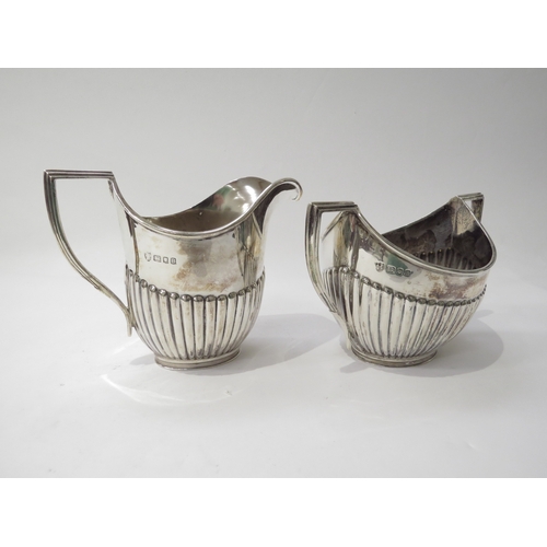 6433 - A Vander & Hedges silver milk jug and sugar bowl with melon fluted detail, London 1937, 10.5cm and 9... 