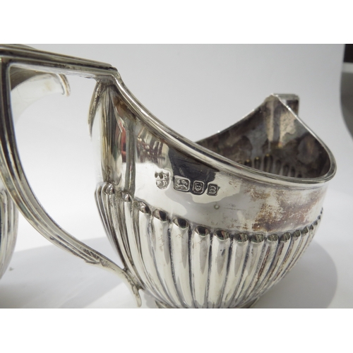 6433 - A Vander & Hedges silver milk jug and sugar bowl with melon fluted detail, London 1937, 10.5cm and 9... 