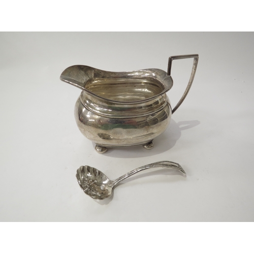 6429 - An S Blanckensee & Son silver milk jug raised on four ball feet, Birmingham 1936 and a misshapen sif... 