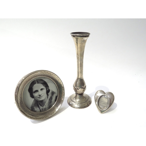 6438 - Two silver photograph frames, one of heart form and a silver spill vase made by Bishtons Ltd, Birmin... 