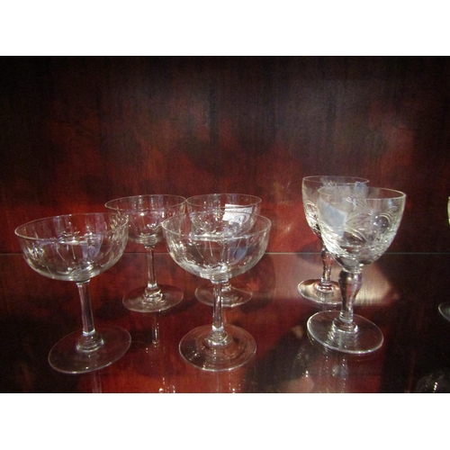 1005 - A pair of Royal Brierly cut wine glasses.  A set of four thumb cut champagne saucers with vine etche... 