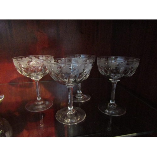 1005 - A pair of Royal Brierly cut wine glasses.  A set of four thumb cut champagne saucers with vine etche... 