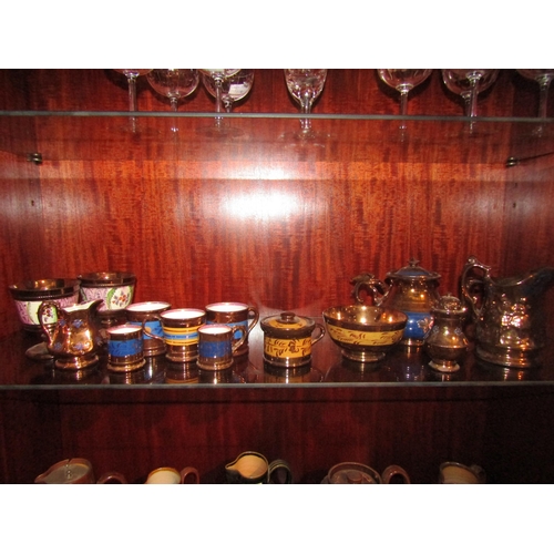 1006 - A collection of Victorian copper lustre table wares including a teapot, a pair of goblets, jugs and ... 