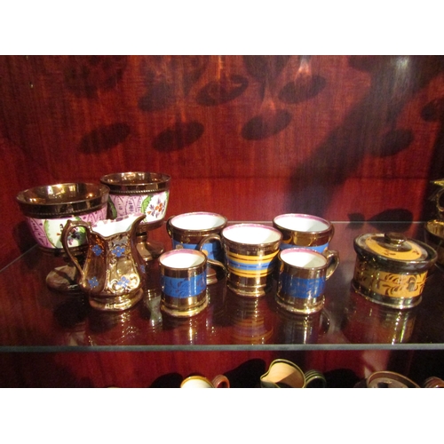 1006 - A collection of Victorian copper lustre table wares including a teapot, a pair of goblets, jugs and ... 