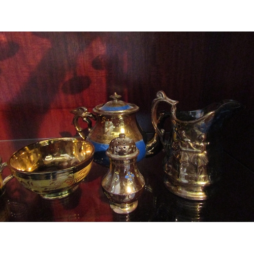 1006 - A collection of Victorian copper lustre table wares including a teapot, a pair of goblets, jugs and ... 