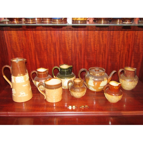 1007 - Five various Doulton Lambeth stoneware milk jugs, applied with taper motifs. A similar mug, teapot a... 