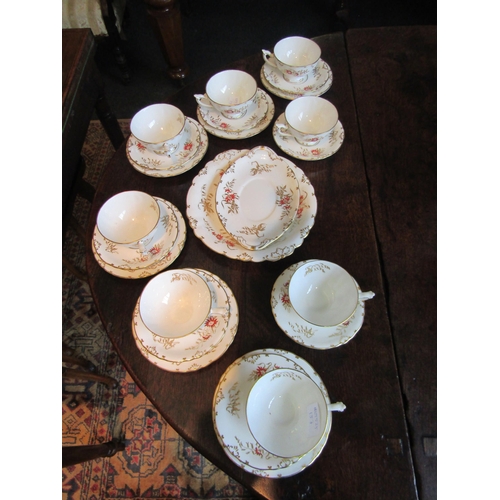 1025 - A Royal Crown Derby bone china part tea service, decorated in gilt and iron red with flowers and lea... 