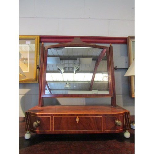 1077 - A 19th Century flame mahogany dressing table mirror, reeded supports, three drawer base, some damage... 