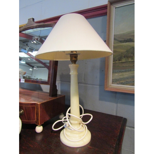 1078 - A pair of onyx table lamps with cream fabric shades