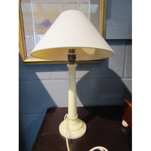 1078 - A pair of onyx table lamps with cream fabric shades