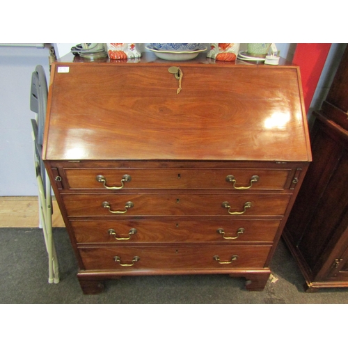 1093 - A 19th Century mahogany bureau, drop-flap with fitted interior, four graduating long drawers on brac... 