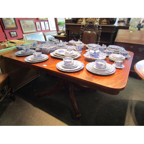 1099 - A Regency flame mahogany tilt-top breakfast table of rectangular form on brass castors