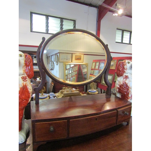 1121 - A 19th Century mahogany bevel edge swing mirror on three drawer base